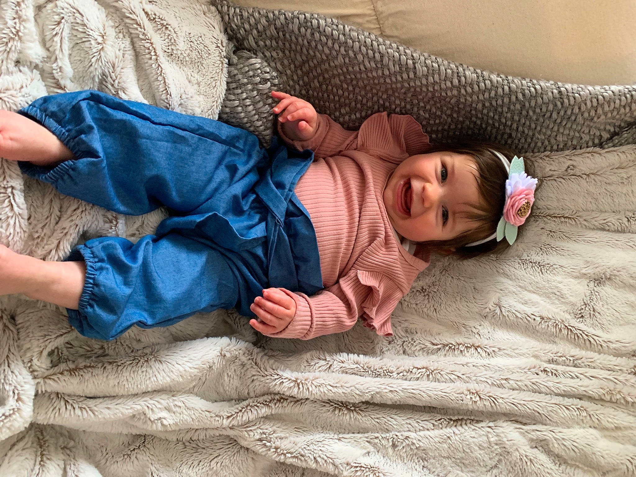 Adelaide is registered to the contest to win money with this photo: baby, baby_toddler_clothing, bedding, child, comfort, eye, flooring, grass, hand, head, human_leg, joint, joy, leg, linens, person, sitting, skin, sleeve, toddler