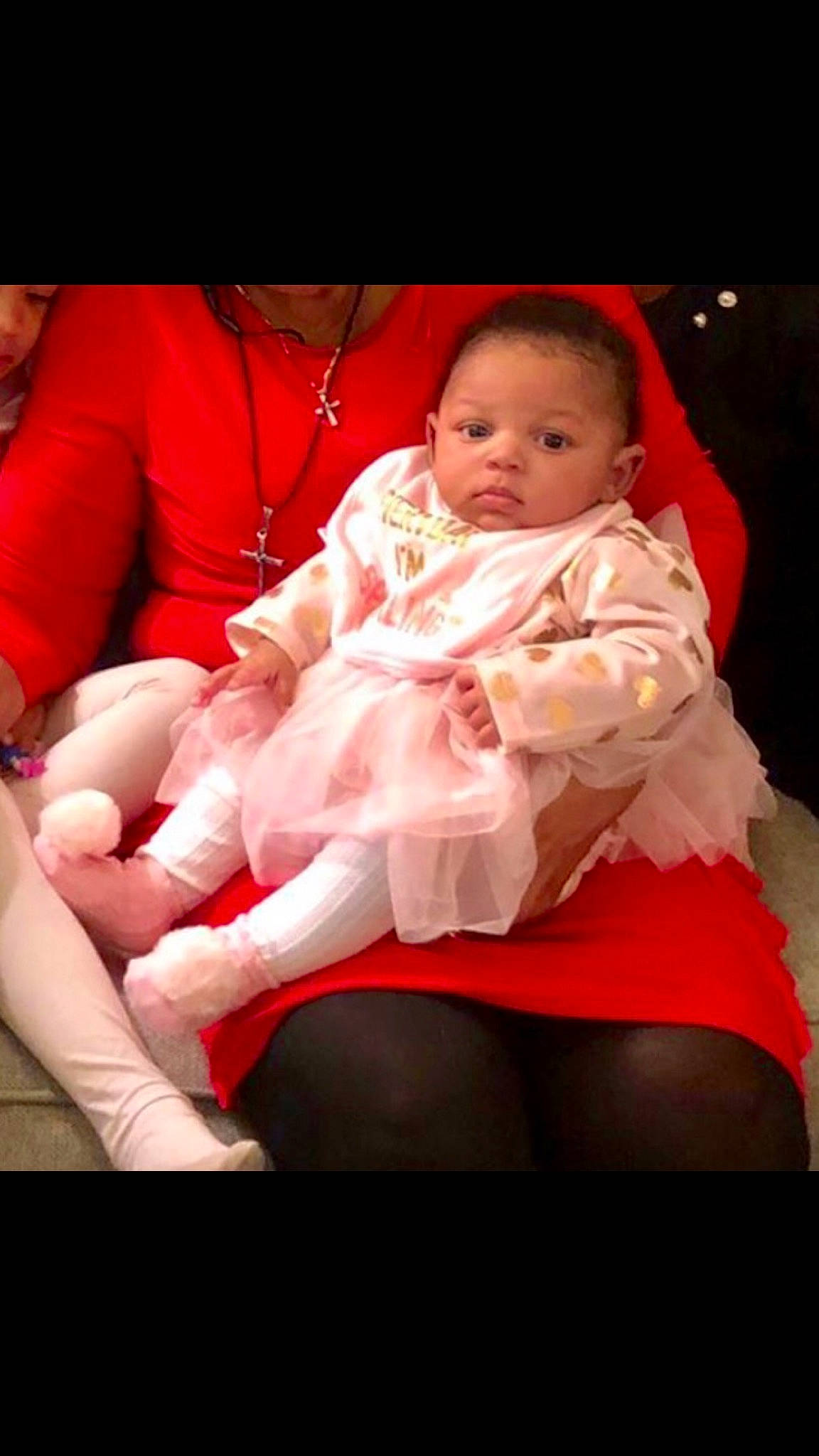 Aniyah is registered to the contest to win money with this photo: arm, baby, cheek, child, flesh, hand, human_body, lap, leg, muscle, person, pink, product, red, sitting, skin, thigh, tights, toddler