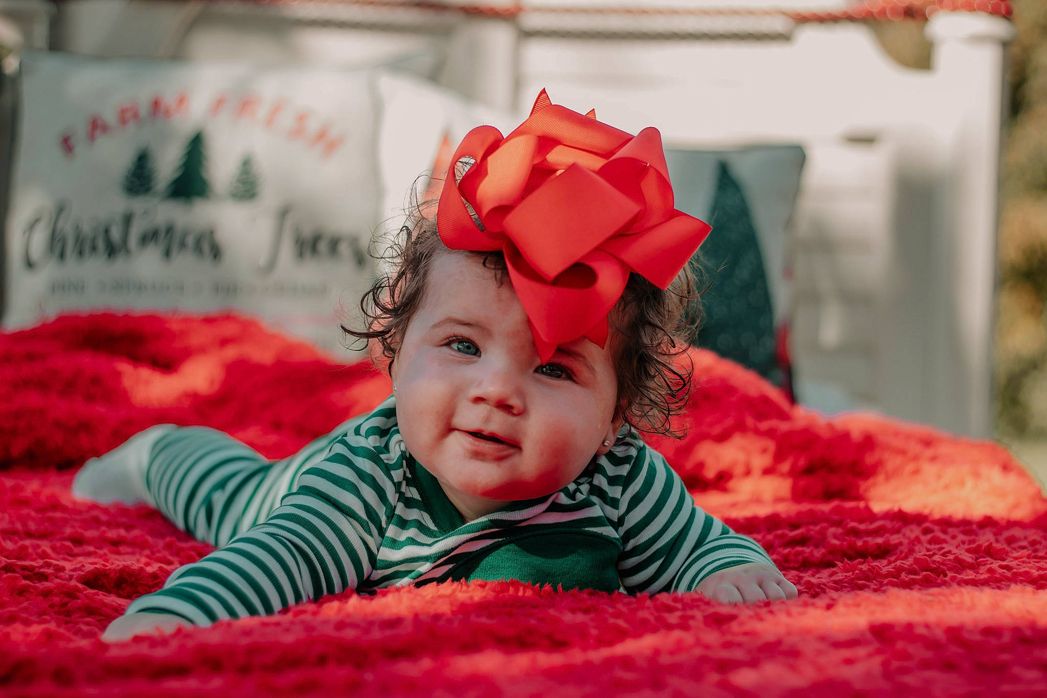 Nalani is registered to the contest to win money with this photo: baby, baby_toddler_clothing, carmine, child, comfort, fun, fur, grass, happy, headwear, linens, magenta, pattern, person, petal, pink, room, sitting, skin, sleeve