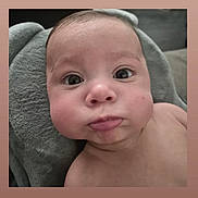 Nolan joined the competition — help win amazing prizes! baby, infant, face, expression, chubby_cheeks, elephant_pillow, soft_texture, skin, portrait, young_child, cute, indoor, head, eyes, mouth, person, child, closeup, baby_face, lying_down