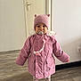 baby, child, cute, door, floor, fur_collar, hat, indoor, pacifier, person, pink_coat, playful, smiling, socks, standing, toddler, warm, winter_clothing, wooden_floor, young_child
