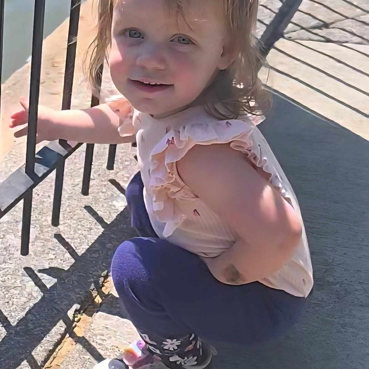 Abigail joined the competition — help win amazing prizes! child, toddler, smiling, outdoor, sunlight, shadow, fence, concrete, shoes, clothing, person, curly_hair, cute, playful, ruffled_top, purple_pants, daylight, happy, young, nature