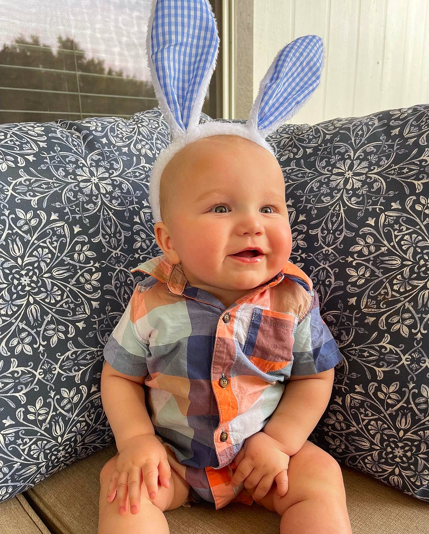 Graham is registered to the contest to win money with this photo: baby, baby_toddler_clothing, blue, comfort, couch, eye, finger, happy, hat, head, human_body, knee, mammal, person, product, skin, sleeve, smile, thigh, toddler