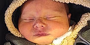 Tobias is registered to the contest to win money with this photo: baby, sleeping, car_seat, hood, coat, straps, infant, child, cute, warm, soft, face, clothing, bundle, safety, transport, indoors, closeup, newborn, resting