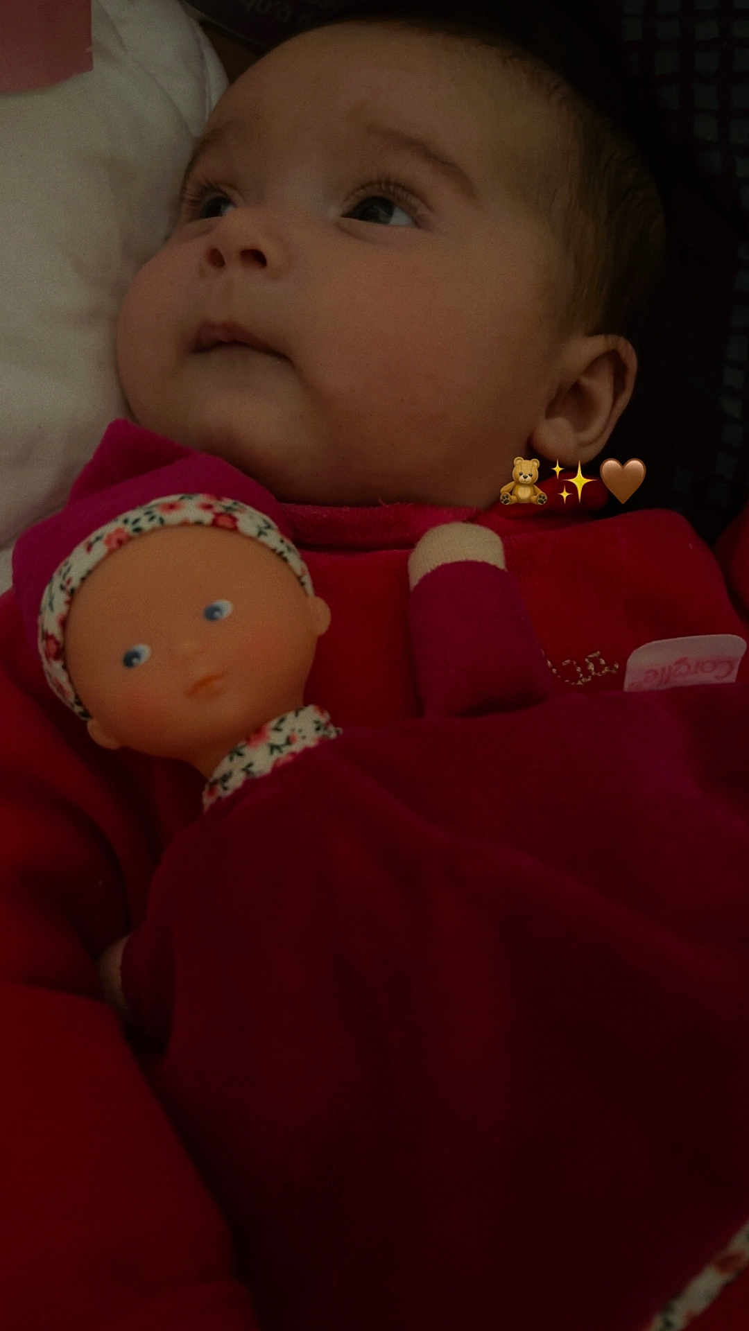 Aleïa a rejoint le concours — aidez-le/la à gagner de superbes lots ! baby, doll, child, red_clothing, portrait, face, closeup, indoor, soft_lighting, expression, toy, cute, infant, headwear, person, sleepwear, cozy, looking_away, plush, young_child