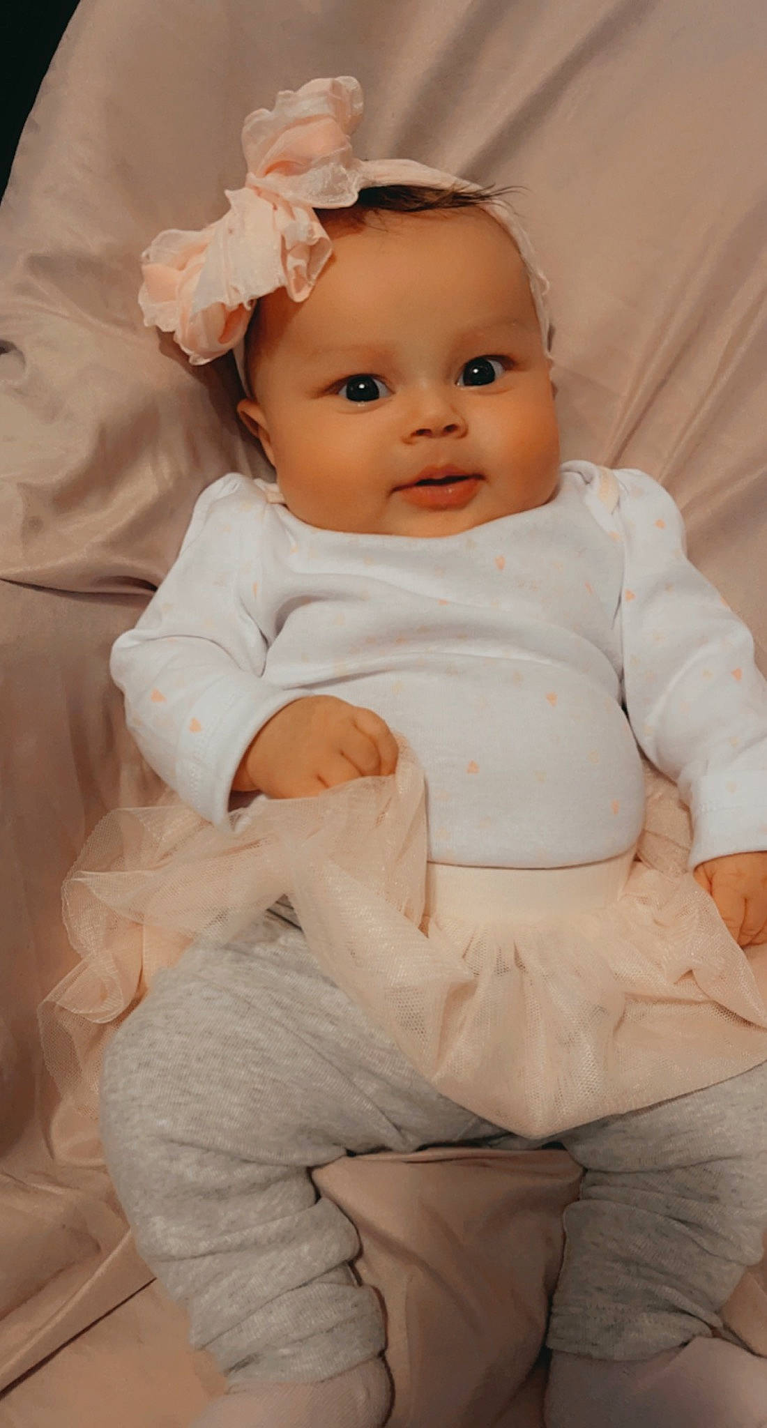 Reigna is registered to the contest to win money with this photo: baby, baby_toddler_clothing, cheek, child, comfort, eye, facial_expression, flash_photography, happy, human_body, iris, lip, person, pink, product, sitting, skin, sleeve, smile, toddler