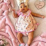 baby, blanket, bow, child, cute, dress, family_photography, floral_pattern, flowers, heart_sign, indoor, infant, lying_down, nursery, pink, plush_bunny, portrait, smiling, sock, stuffed_animal