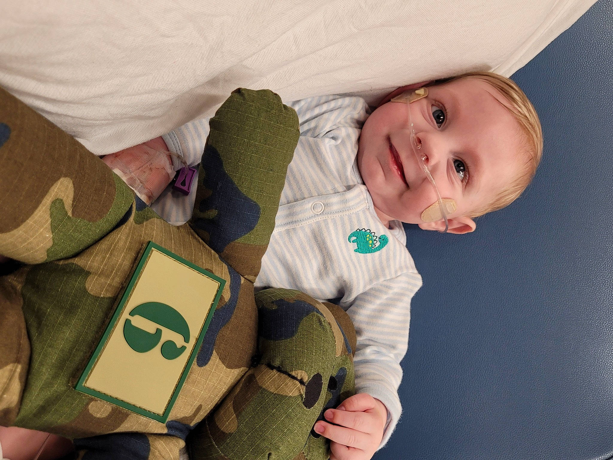 Lachlan is registered to the contest to win money with this photo: baby, baby_products, baby_safety, baby_toddler_clothing, camouflage, cheek, child, comfort, couch, happy, joy, military_camouflage, pattern, person, room, sitting, sleeve, smile, textile, thumb