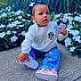 toddler, child, outdoor, plants, flowers, sidewalk, white_sweater, minnie_mouse, blue_pants, pink_shoes, grass, greenery, cute, curious, sitting, hair_bows, nature, casual_clothing, daylight, person