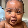 Tymir is registered to the contest to win money with this photo: baby, bare_chested, bath_time, caregiver_present, child, close_up, curly_hair, dark_skin, eyes, face, happy, home, indoors, infant, photography, portrait, sitting, smiling, water, wet