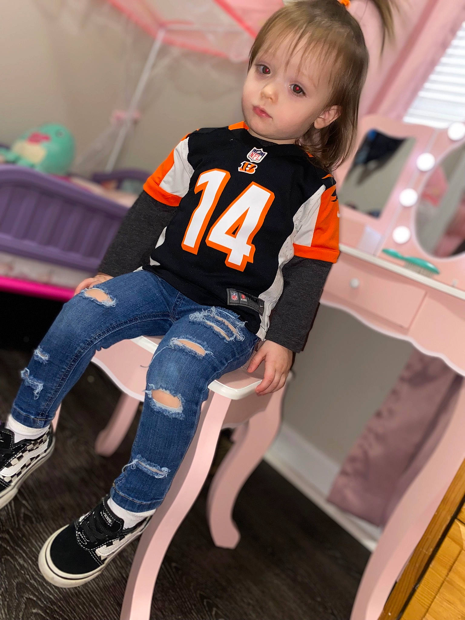 Bristol is registered to the contest to win money with this photo: chair, child, electric_blue, fashion, fashion_design, flooring, foot, fun, human_leg, knee, leisure, orange, person, sandal, sitting, sleeve, sock, sportswear, thigh, toddler