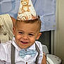 Loan a rejoint le concours — aidez-le/la à gagner de superbes lots ! child, toddler, party_hat, smile, bow_tie, suspenders, white_shirt, celebration, birthday, teddy_bear, face, person, happy, indoor, table, adult_hand, nail_polish, button, highchair, background