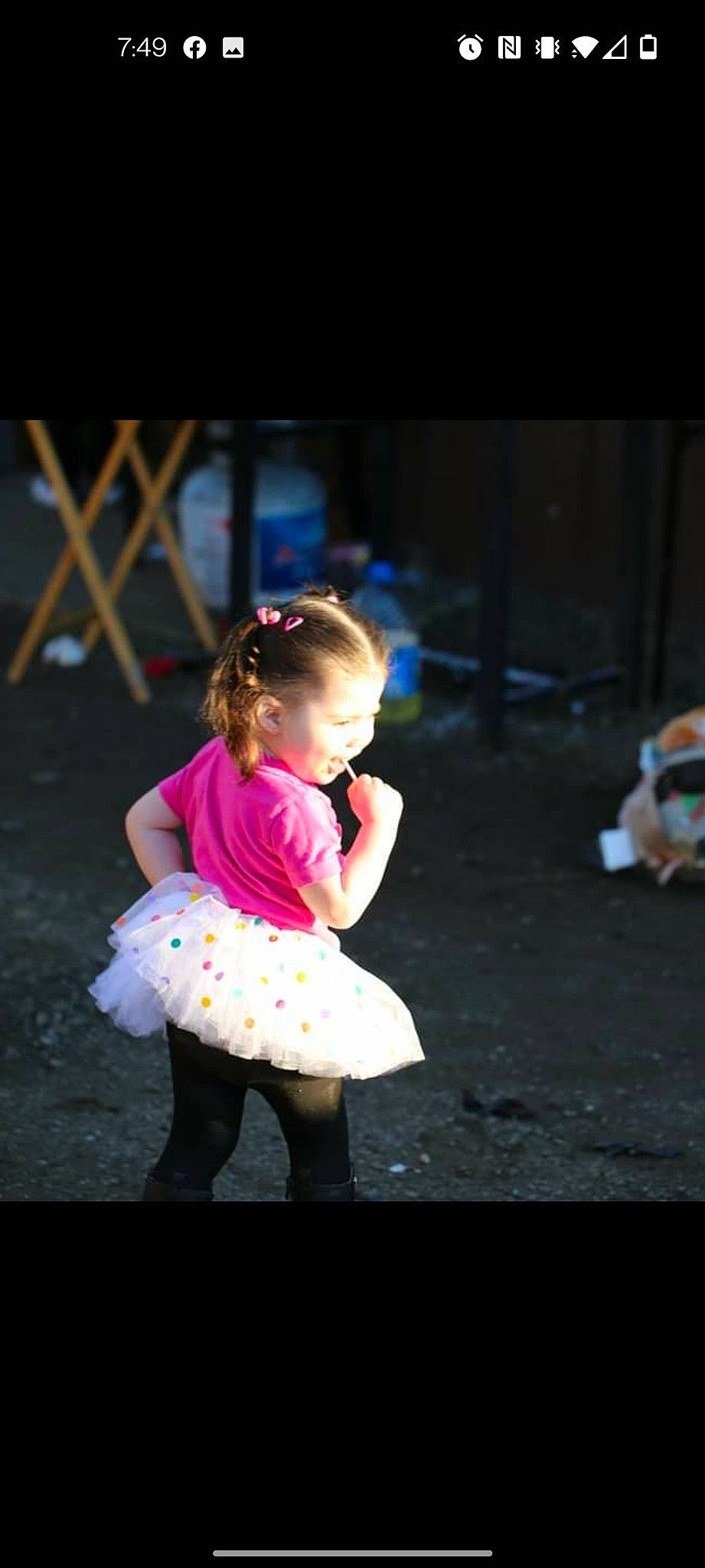 Amanda is registered to the contest to win money with this photo: asphalt, child, darkness, dress, entertainment, event, fashion_design, flash_photography, fun, grass, happy, human_leg, leg, leisure, magenta, performing_arts, person, recreation, shoulder, toddler