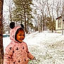 child, girl, snow, winter, hoodie, pink_clothing, smiling, outdoor, tree, grass, house, satellite_dish, playful, cold_weather, happy, nature, daytime, jacket, cute, fun