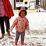 child, snow, winter_clothing, pink_jacket, mickey_mouse_ears, gloves, boots, snowfall, outdoor, grass, trailer, happy, playful, person, adult, red_jacket, pants, smile, cold_weather, snowy_ground
