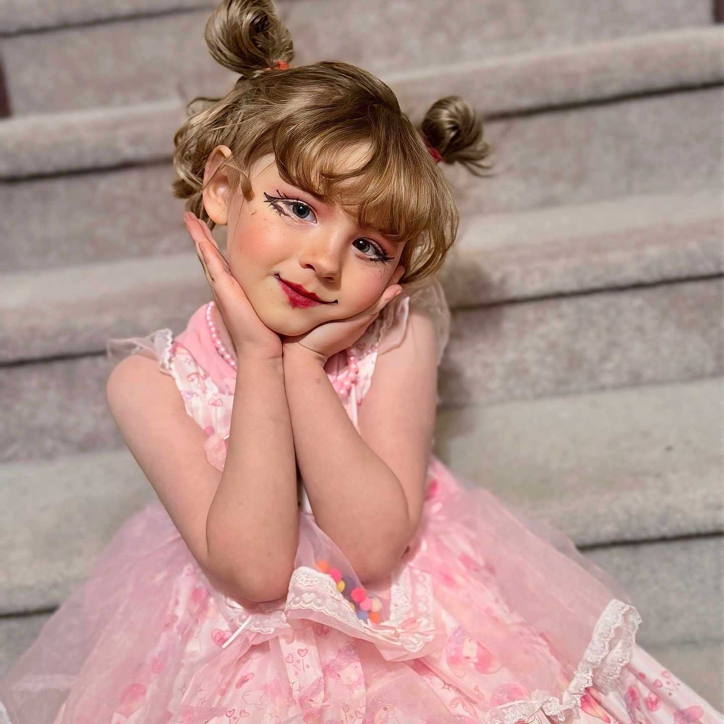 November is registered to the contest to win money with this photo: beads, blonde_hair, child, cute, dress, eyeliner, girl, hands_on_face, indoor, lace, makeup, pigtails, pink_dress, playful, portrait, rosy_cheeks, sitting, smile, stairs, tulle