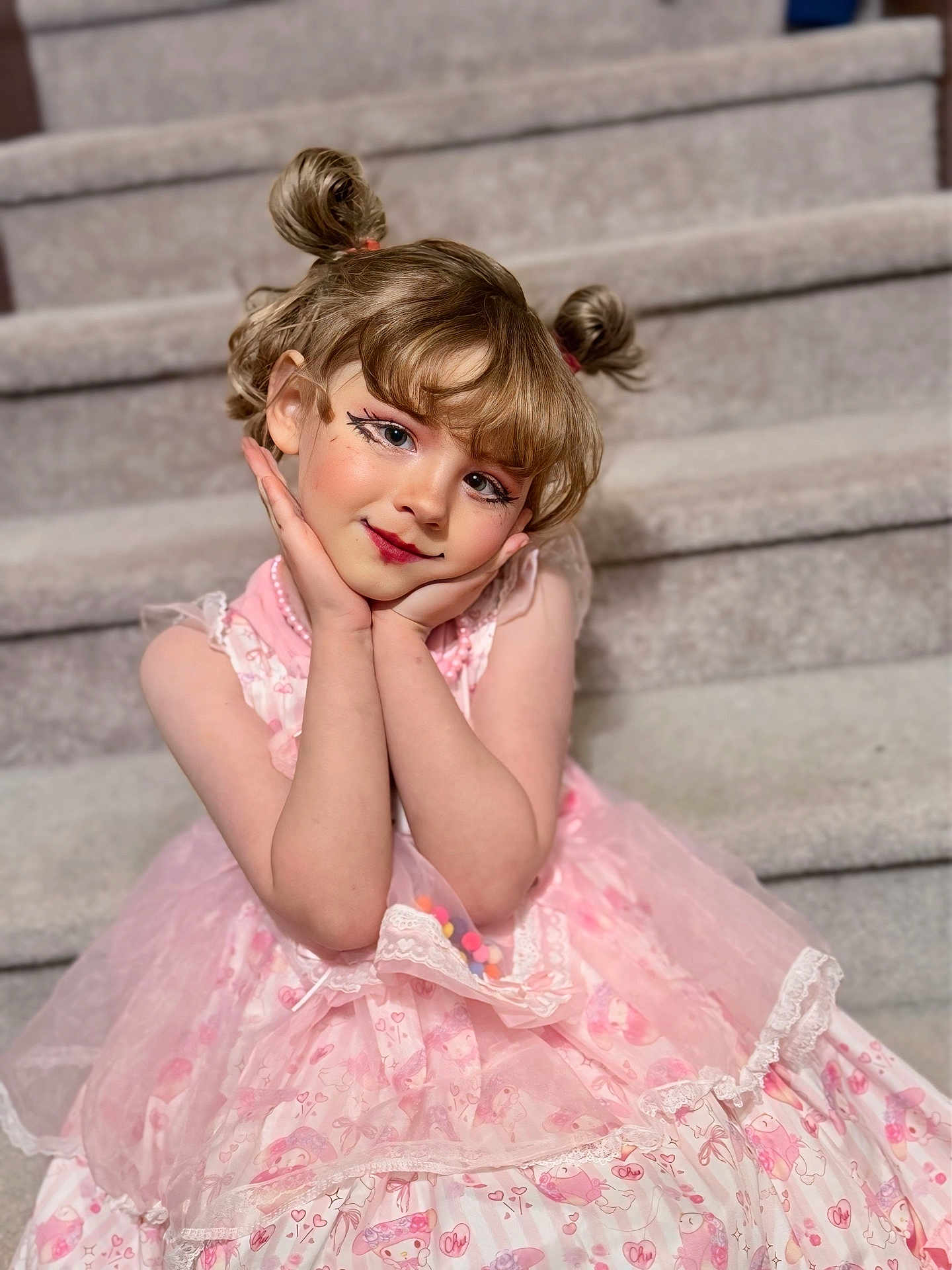 November is registered to the contest to win money with this photo: child, girl, dress, pink_dress, pigtails, makeup, stairs, portrait, smile, sitting, cute, indoor, rosy_cheeks, hands_on_face, eyeliner, beads, tulle, lace, blonde_hair, playful