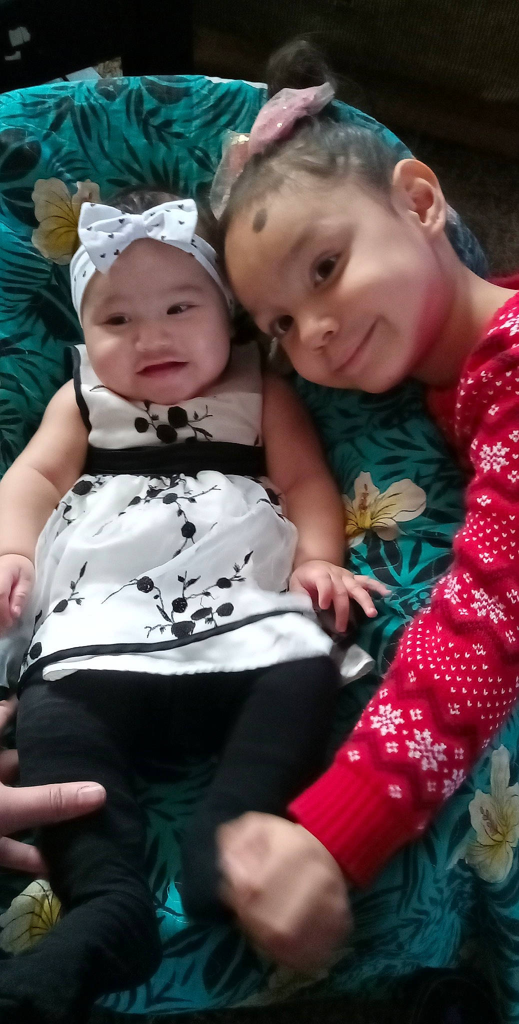 Joyce is registered to the contest to win money with this photo: baby, baby_toddler_clothing, child, event, face, facial_expression, fun, grass, happy, hat, headwear, joy, leisure, pattern, person, photograph, pink, sitting, skin, sleeve