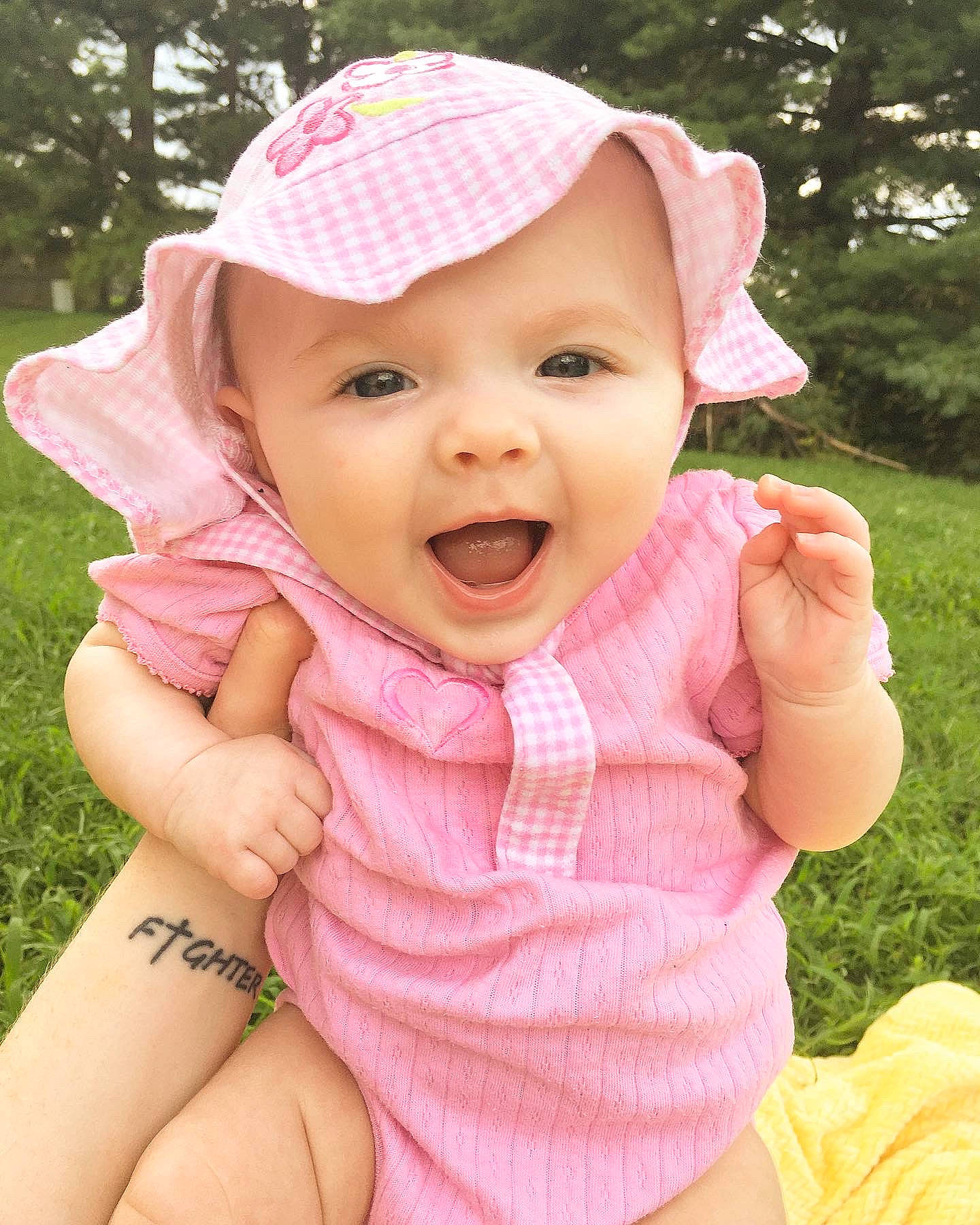 Coco is registered to the contest to win money with this photo: baby, baby_toddler_clothing, beauty, cheek, child, child_model, face, facial_expression, grass, happy, headgear, headwear, lip, mouth, nose, person, pink, product, skin, smile