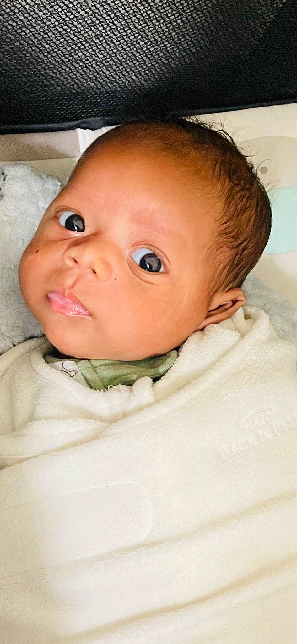 Osiah is registered to the contest to win money with this photo: baby, baby_toddler_clothing, cheek, child, comfort, eyelash, fun, happy, iris, linens, lip, no_expression, nose, person, portrait_photography, room, sitting, skin, sleeve, smile