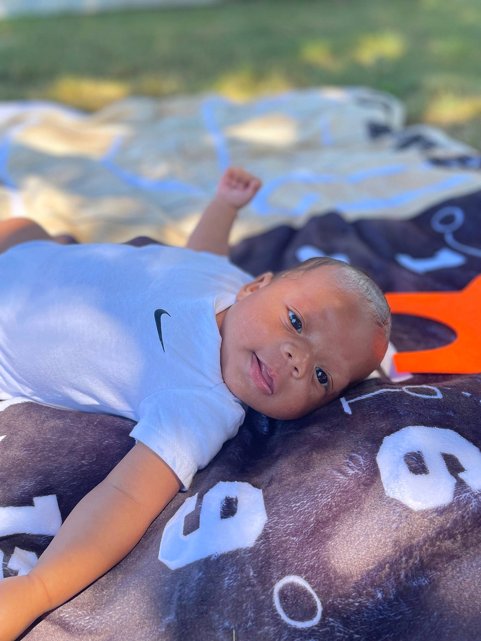 Osiah is registered to the contest to win money with this photo: abdomen, baby, baby_products, child, competition_event, fun, grass, happy, leisure, person, personal_protective_equipment, sitting, sleep, toddler, toy, vacation