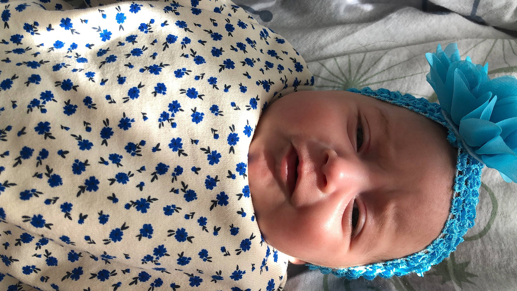 Assia participe au concours pour gagner de l'argent avec cette photo : azure, baby, baby_toddler_clothing, beauty, blue, cheek, child, comfort, electric_blue, facial_expression, grass, happy, headwear, linens, pattern, person, portrait_photography, sleeve, smile, textile
