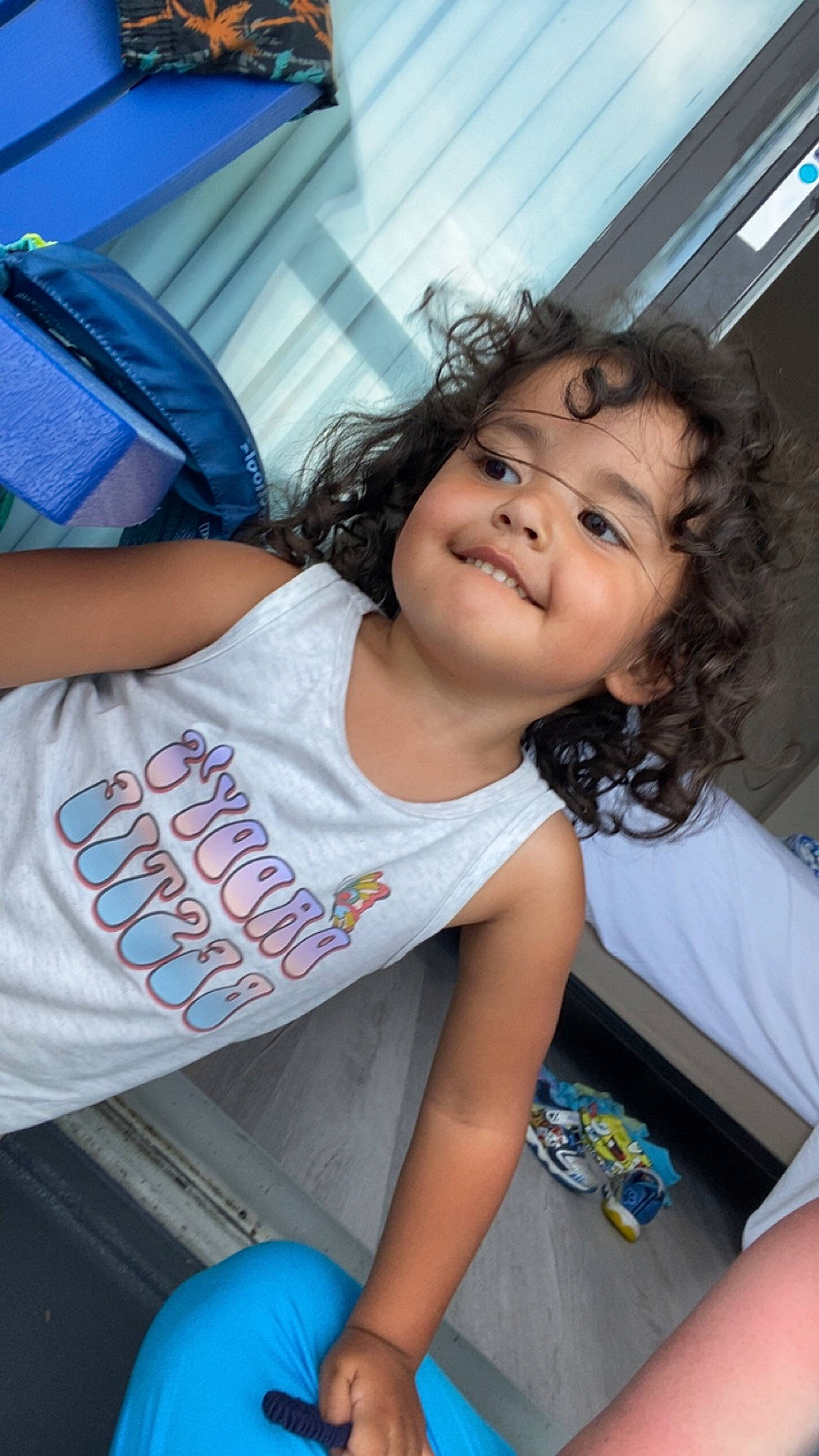 Madilyn is registered to the contest to win money with this photo: black_hair, blue, child, cool, elbow, eye, fun, hairstyle, happy, joint, joy, leisure, mouth, person, shoulder, skin, smile, summer, t_shirt, thigh