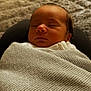 Oscar is registered to the contest to win money with this photo: newborn, baby, sleeping, blanket, knitted, cozy, infant, peaceful, wrapped, soft_lighting, portrait, closeup, rest, cute, serene, indoors, child, head, face, person