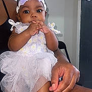 Bloom joined the competition — help win amazing prizes! baby, child, infant, dress, headband, flower, purple, socks, hand, lap, adult, indoor, door, chair, skin, cute, curious, person, seated, closeup