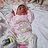 Ari is registered to the contest to win money with this photo: newborn, baby, sleeping, pajamas, pink, hat, blanket, soft, cute, infant, clothing, cartoon, pattern, cozy, resting, indoors, child, person, cute_outfit, peaceful