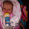 baby, infant, bottle, formula, blanket, pink, wrapped, person, face, head, hand, clothing, newborn, expression, portrait, indoor, cute, child, feeding, warm