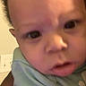 Jyaire is registered to the contest to win money with this photo: baby, child, closeup, clothing, curious, cute, expression, face, green_shirt, hand, head, human, indoors, infant, looking, newborn, person, portrait, skin, young