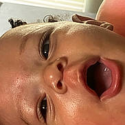 Jyaire is registered to the contest to win money with this photo: baby, face, close_up, skin, mouth, eyes, hair, infant, expression, indoors, child, portrait, head, curly_hair, sleepy, young, person, cute, natural_light, soft
