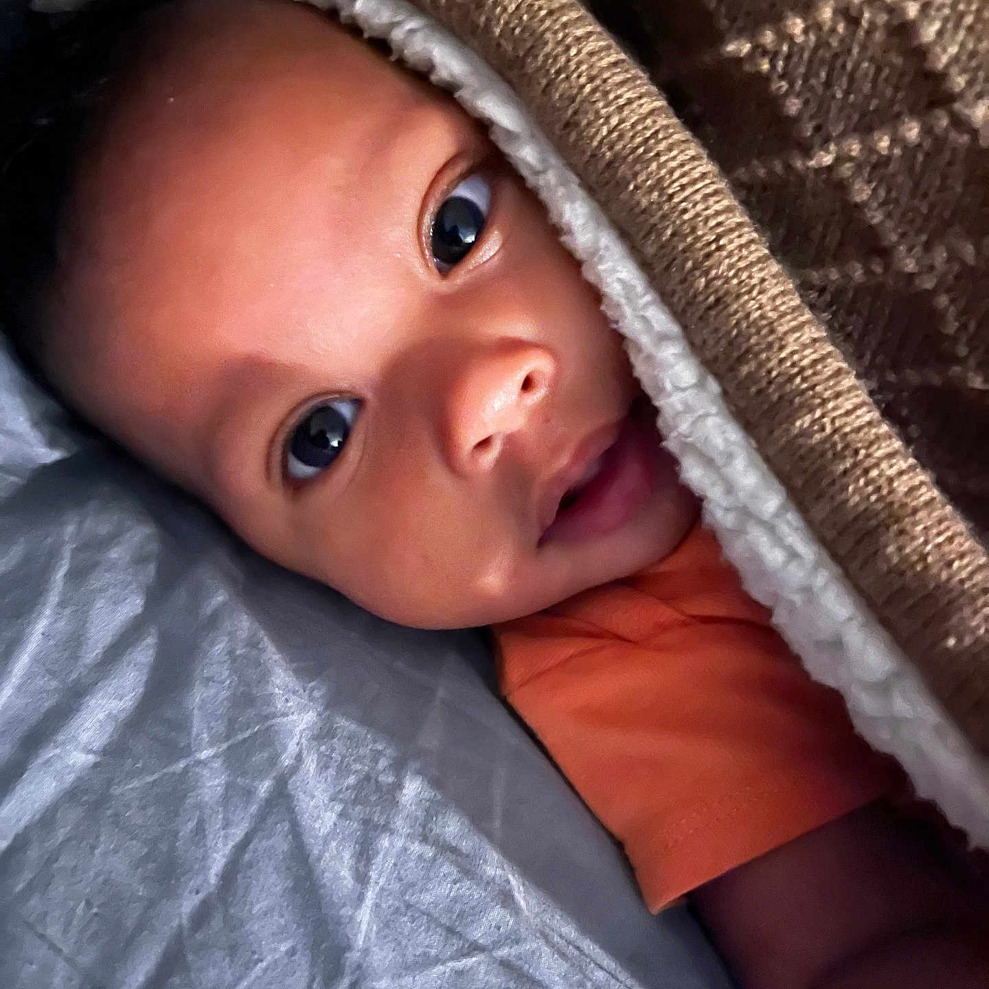 Braxton is registered to the contest to win money with this photo: baby, blanket, bodypart, bonnet, cap, clothing, face, finger, hand, happy, hat, head, hiding, hood, newborn, person, photography, portrait, quilt, smile