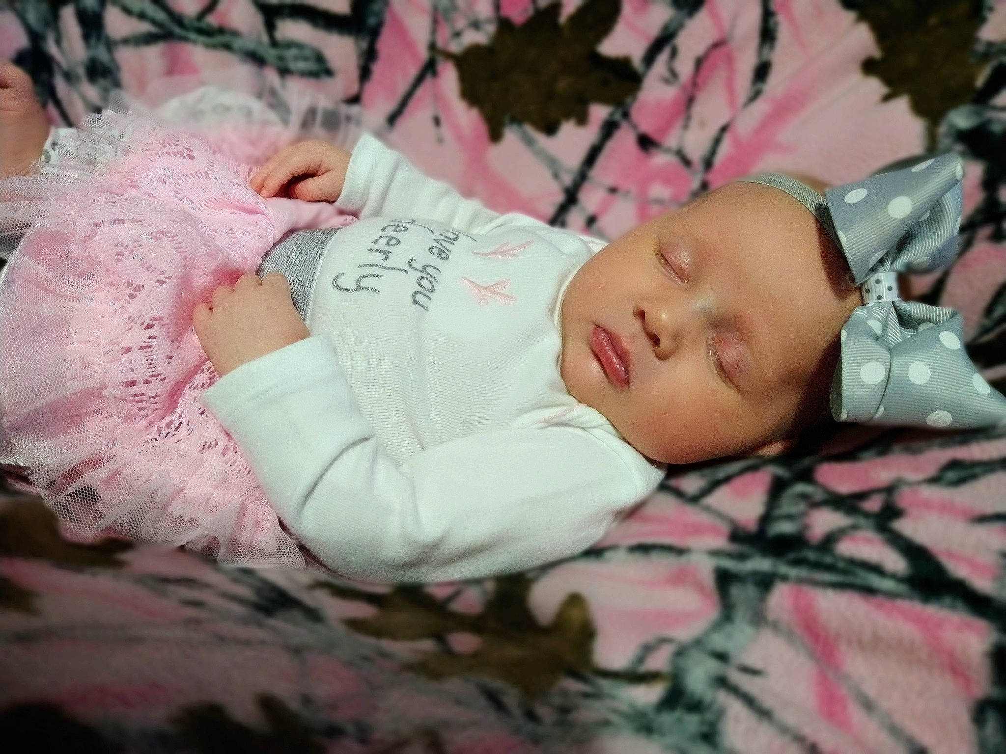 Diana is registered to the contest to win money with this photo: arm, baby, baby_toddler_clothing, child, comfort, eye, eyelash, fashion_accessory, flash_photography, hand, happy, head, headgear, headwear, human_body, pattern, person, pink, skin, sleeve