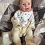 Lily joined the competition — help win amazing prizes! baby, bed, bib, blanket, child, clothing, comfort, cute, fabric, face, happy, indoors, infant, lying_down, onesie, pattern, person, quilt, smiling, soft