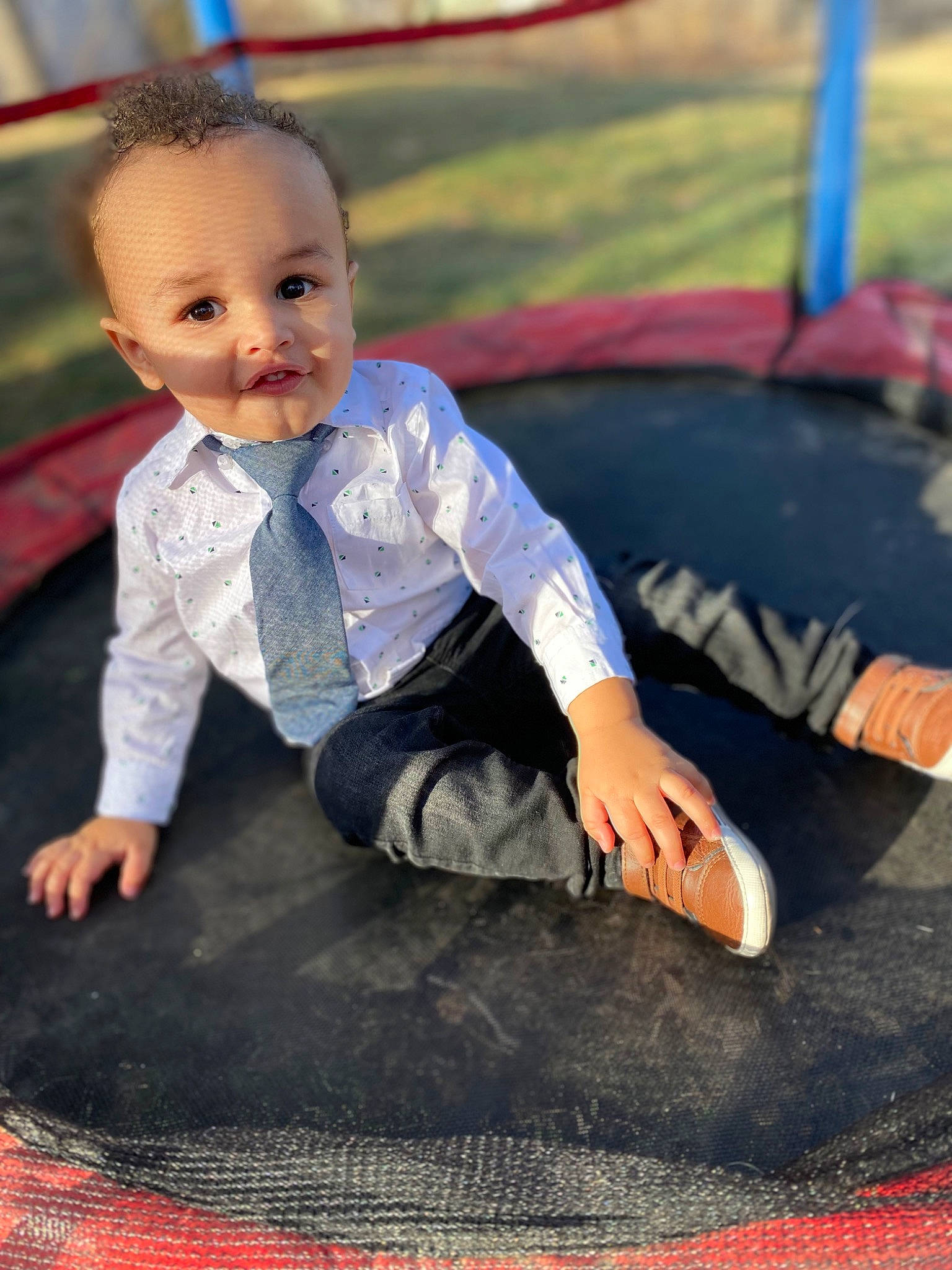 Liam is registered to the contest to win money with this photo: asphalt, baby, black, child, denim, electric_blue, facial_expression, flash_photography, flooring, fun, grass, happy, leisure, outdoor_play_equipment, person, recreation, sitting, smile, swing, t_shirt