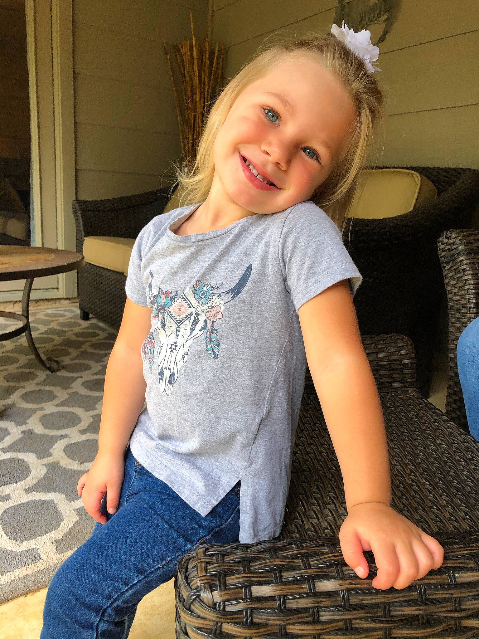 Joyce is registered to the contest to win money with this photo: arm, blond, child, child_model, finger, floor, flooring, fun, hairstyle, jeans, joy, leg, long_hair, organ, pattern, person, play, sitting, smile, t_shirt