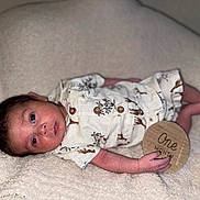 Aramis joined the competition — help win amazing prizes! baby, infant, one_month, blanket, clothing, wooden_sign, lying_down, cute, newborn, portrait, child, soft_texture, animal_print, hand, face, eyes, skin, button, cozy, milestone