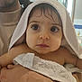 baby, child, towel, wet_hair, indoor, person, adult_hand, bath_time, close_up, curious_eyes, soft_texture, skin, portrait, holding, face, newborn, cute, family, caring, warm