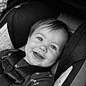 baby, child, car_seat, smile, face, black_and_white, infant, seatbelt, clothing, happy, portrait, safety, cute, young_child, hair, eyes, car, infancy, seat, person