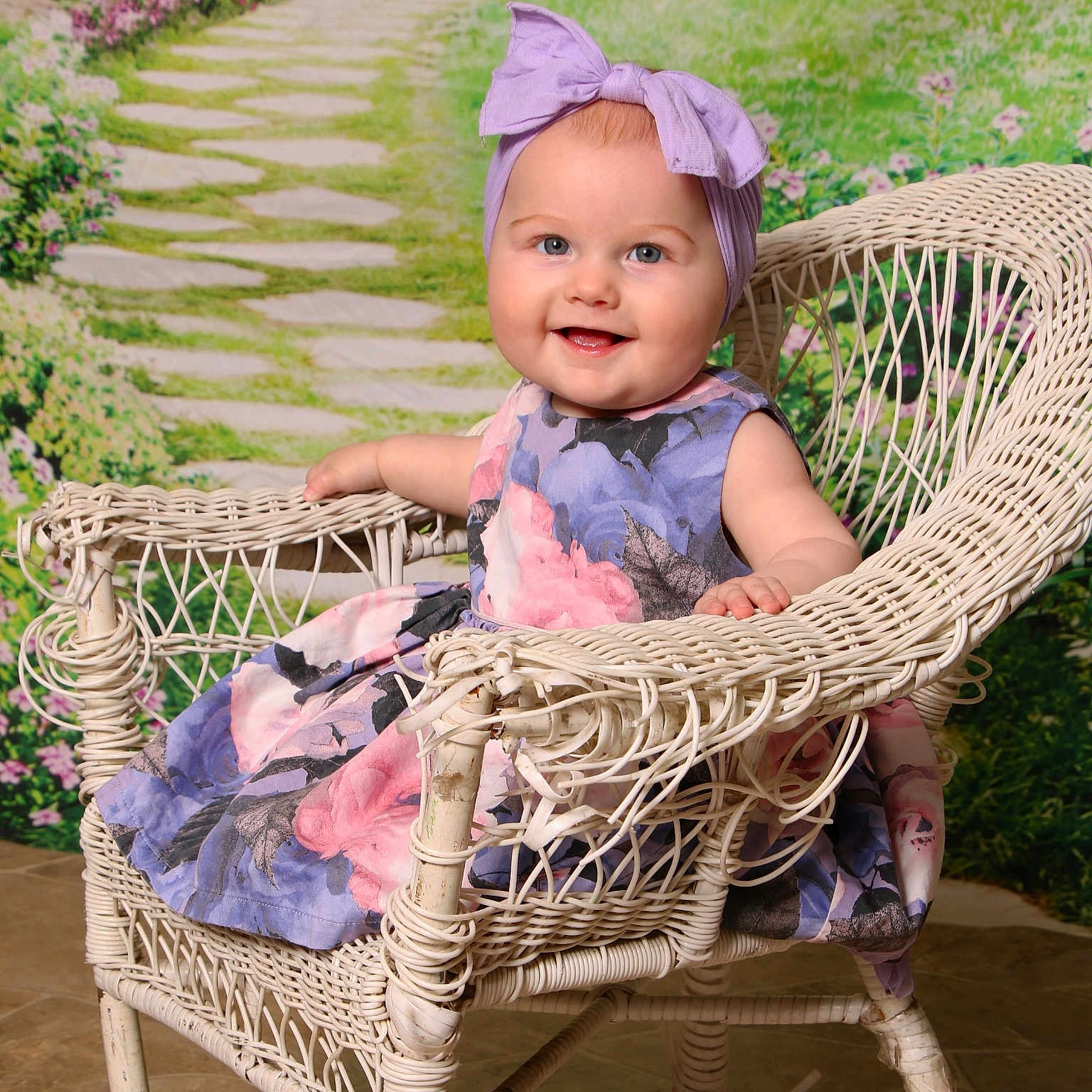 Delilah joined the competition — help win amazing prizes! baby, bonnet, cap, chair, clothing, dress, face, flower, furniture, grass, hat, head, outdoors, path, person, photography, plant, portrait, sitting, walkway