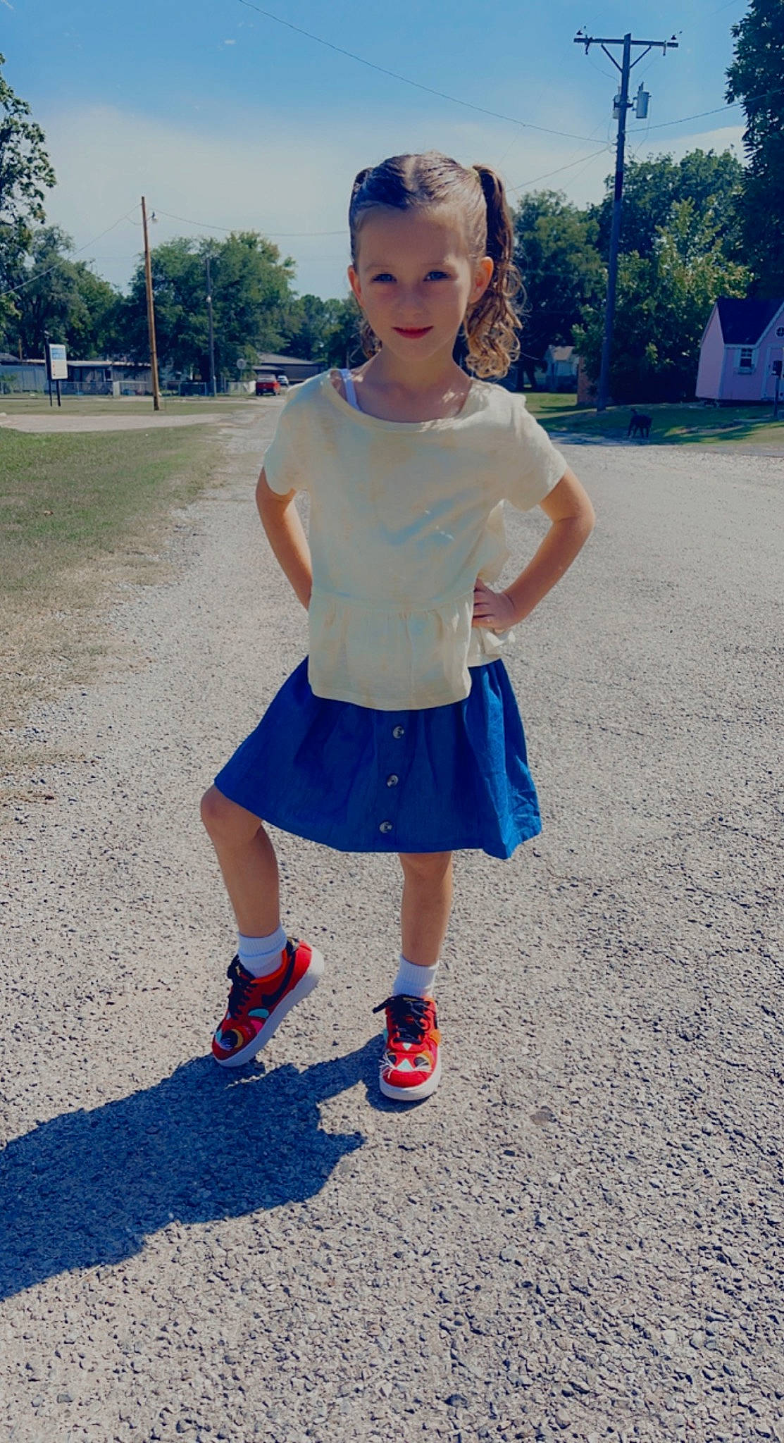 Gracie is registered to the contest to win money with this photo: asphalt, denim, electric_blue, eye, fun, grass, happy, human_leg, leisure, magenta, person, plant, recreation, sky, sleeve, standing, summer, t_shirt, toddler, tree