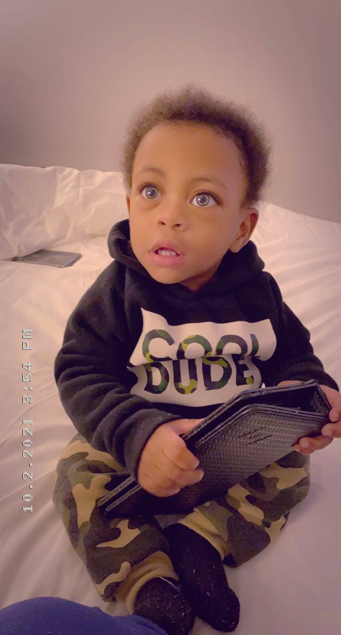 Emir is registered to the contest to win money with this photo: baby, baby_toddler_clothing, cheek, child, comfort, finger, flooring, happy, head, iris, jacket, mouth, nose, outerwear, person, skin, sleeve, standing, t_shirt, thumb