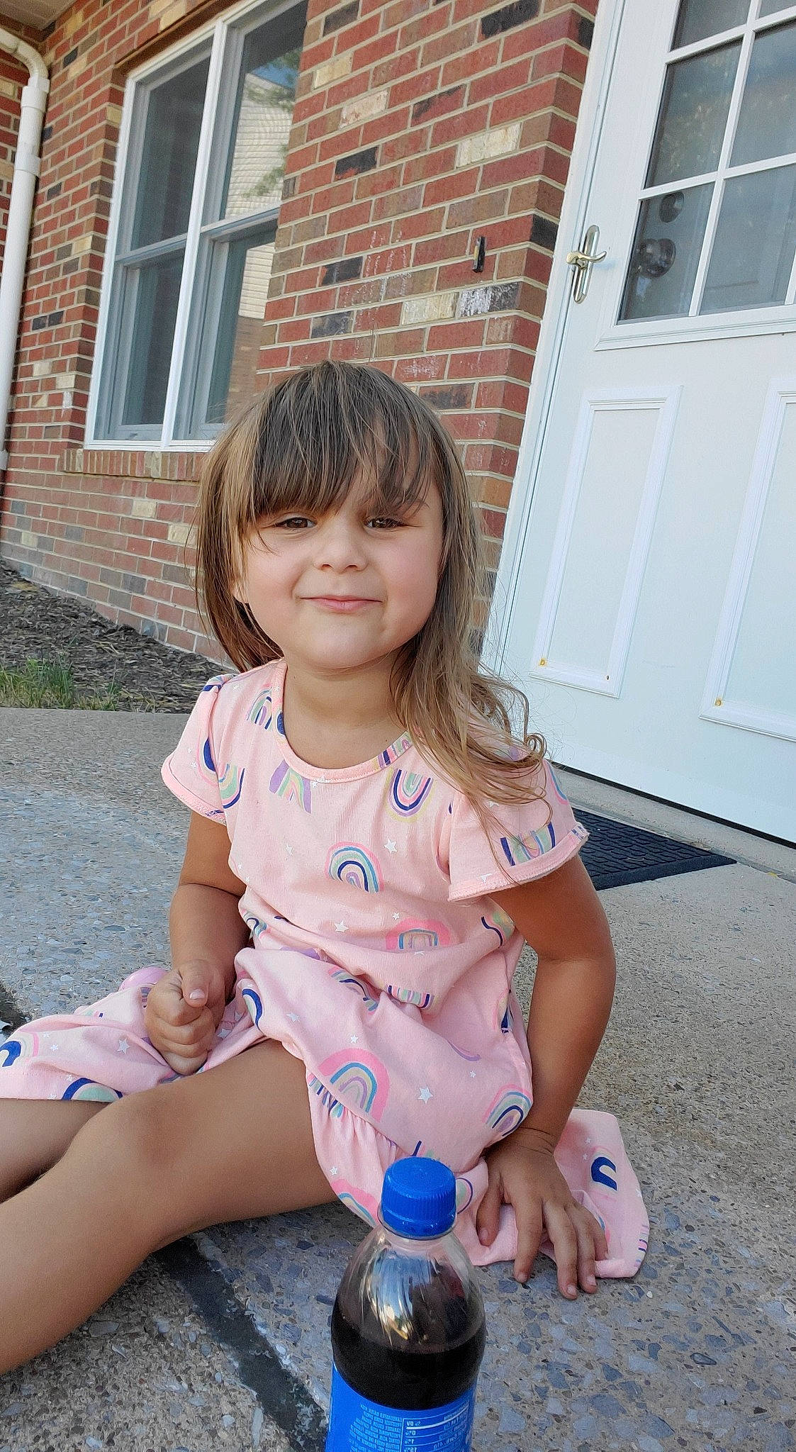 Mattie is registered to the contest to win money with this photo: baby, baby_toddler_clothing, bottle, brick, brickwork, child, door, door_handle, home_door, human_body, joy, nail, overall, person, pink, plastic_bottle, sash_window, summer, toddler, water_bottle