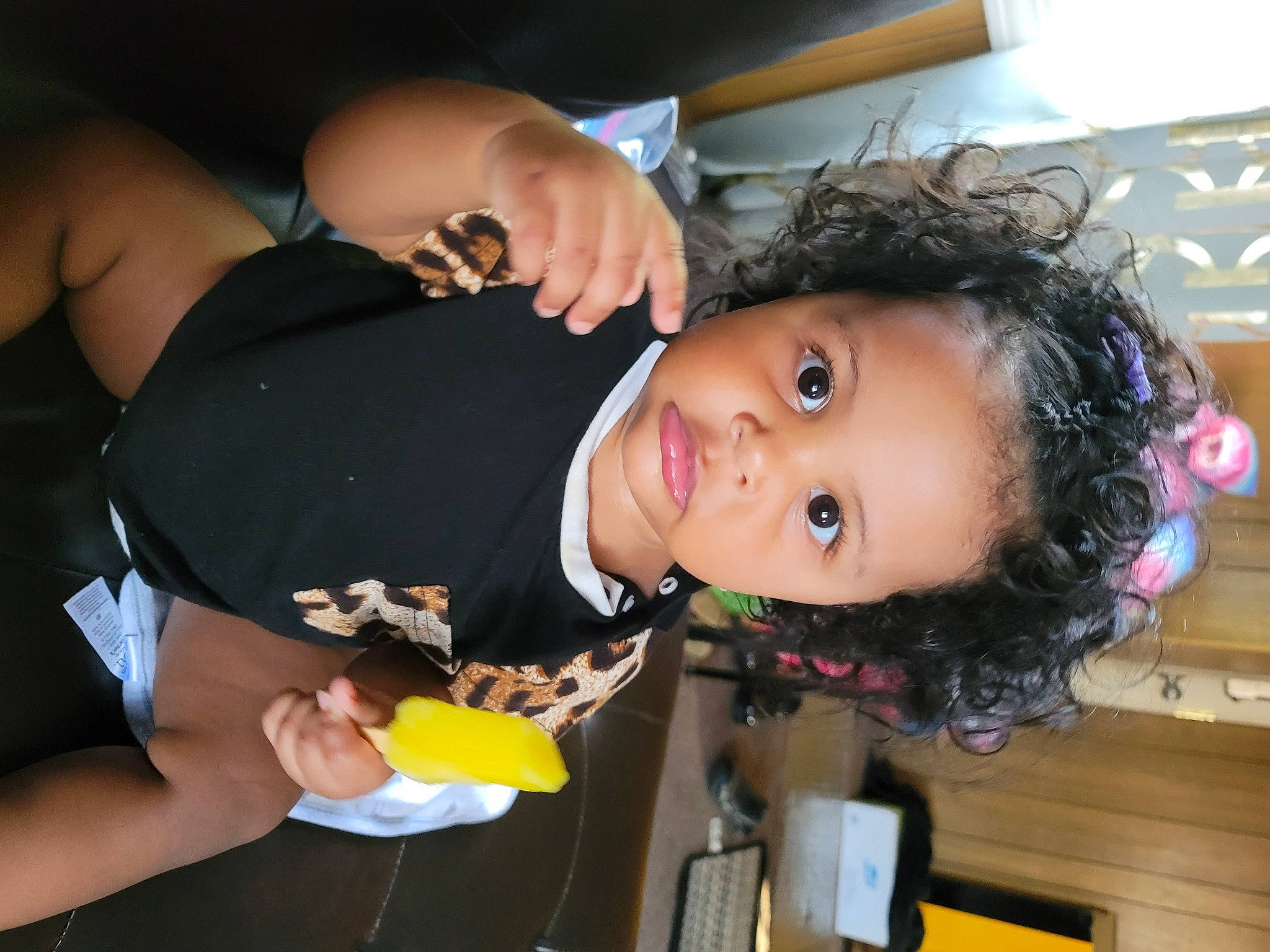 Nina is registered to the contest to win money with this photo: abdomen, black_hair, chest, child, ear, elbow, event, eyelash, fun, gesture, happy, nail, person, room, thigh, thumb, toddler, trunk, wrist