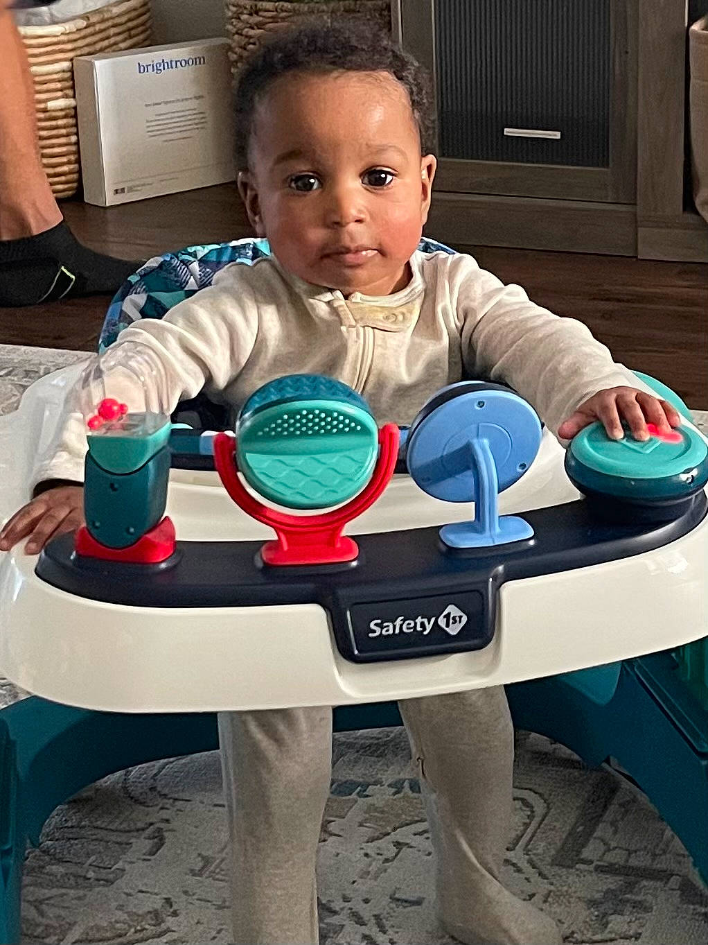 Micah is registered to the contest to win money with this photo: baby, basin, bodypart, chair, desk, diningtable, face, finger, furniture, hand, head, highchair, person, photography, play, portrait, sitting, student, table, toy