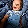 toddler, child, smiling, happy, blue_clothing, striped_shirt, blanket, bed, portrait, cute, baby, one_person, indoor, face, skin, short_hair, dimple, expressive, relaxed, comfort