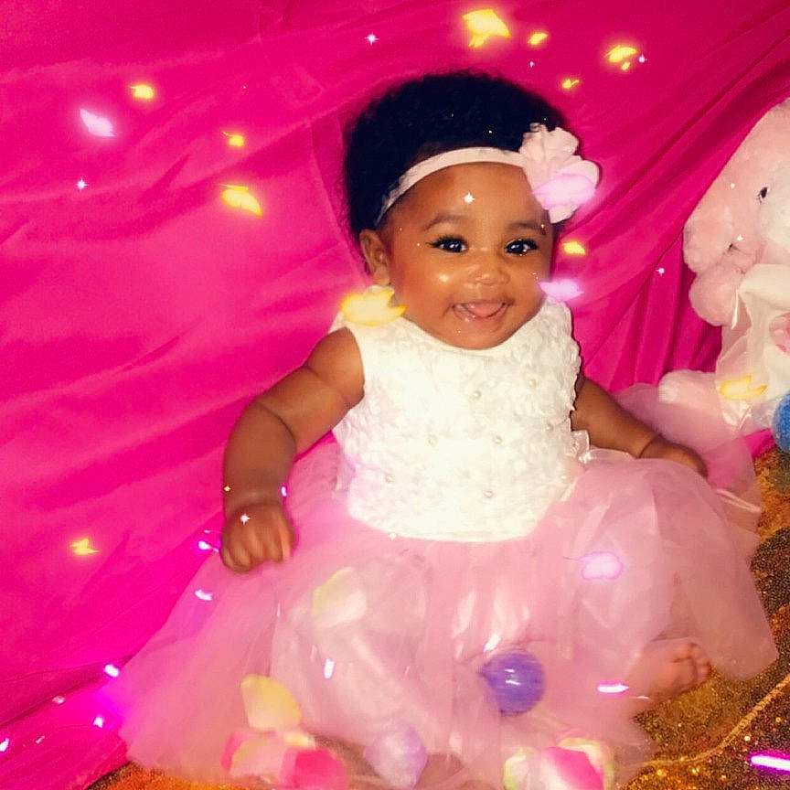 Island is registered to the contest to win money with this photo: child, doll, fun, happy, joy, person, pink, smile, toddler