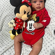 Layla joined the competition — help win amazing prizes! baby, infant, plush_toy, minnie_mouse, red_clothing, blanket, polka_dots, cute, child, soft_texture, lying_down, toy, smiling_face, indoors, portrait, young_child, human, toddler, sleepwear, cuddly